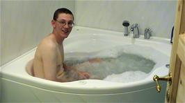 Oliver demonstrates the side jets AND the bubbles in the Jacuzi at the Langenuen Motel, Jektavik